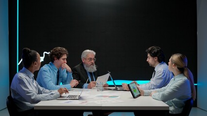 Business people research company conference. Multiethnic managers and ceo team leader having meeting with financial data visual graphic on big digital screen.