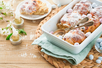 Easter Hot cross buns. Traditional Easter treats cross buns with raisins, butter, chocolate candy...