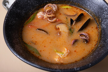 Close up Tom yum soup and rice on a gray background angle view