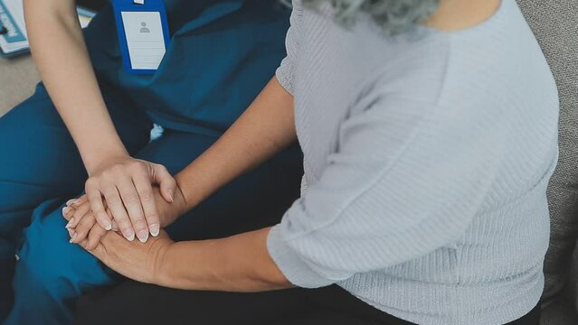 Emotional comfort stored in fingerprints. Shot of an unrecognizable doctor holding hands with her patient during a consultation.