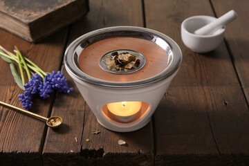 Burning incense (frankincense, resins and herbs) in an incense burner with tea light, mortar and...