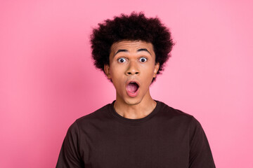 Portrait of young student guy open mouth when saw his exam test results surprised funny emotions isolated on pink color background