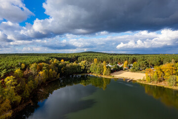 Aerial shot of beautiful lake surrounded by forest in a calm autumn day. Germany. - 758990360