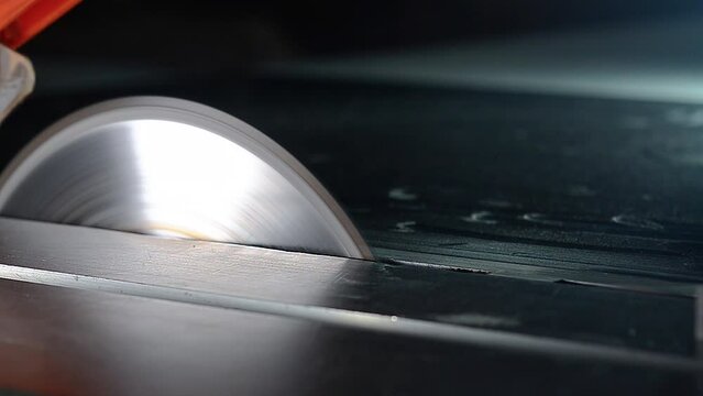 Circular saw cutting chipboard in workshop