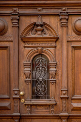 forged decorative elements on wooden doors.  beautiful retro doors. metal decoration on the door. wooden carved doors