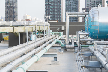 Water pipes system and hot water boiler system tank at rooftop of building. Hot water buffer tank...
