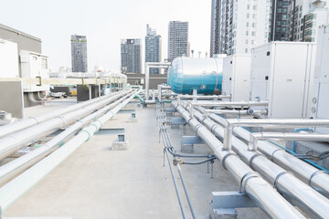 Water pipes system and hot water boiler system tank at rooftop of building. Hot water buffer tank...
