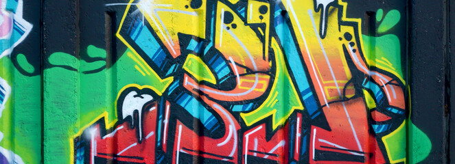 Colorful background of graffiti painting artwork with bright aerosol outlines on wall. Old school...