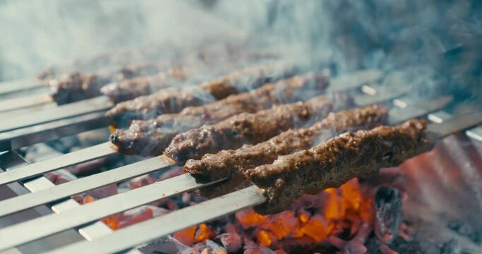 Cooking Adana kebab on the barbecue