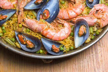 Freshly cooked seafood paella with vibrant colors served in a rustic pan, typical Spanish cuisine, Majorca, Balearic Islands, Spain