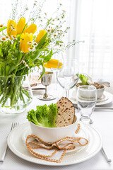 A Passover table setting with a bouquet of tulips	