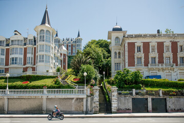 Urban architecture in San Sebastian, Spain. View from the promenade along the coastline in San Sebastian. - obrazy, fototapety, plakaty