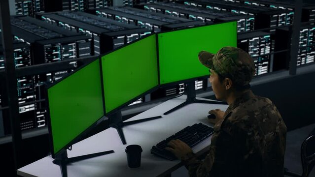 Side View Of Happy Asian Military Celebrating While Working With Mock Up Multiple Computer Monitor In Data Center