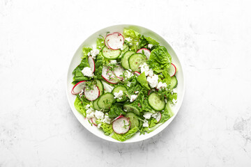 Radish and cucumber fresh green leafy vegetable salad with romaine lettuce, cottage cheese and yogurt, top view - 759028106