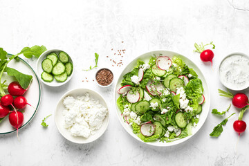 Radish and cucumber fresh green leafy vegetable salad with romaine lettuce, cottage cheese and yogurt, top view - 759028179