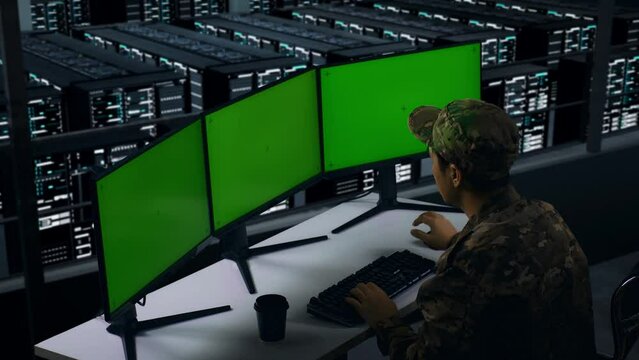 Side View Of Asian Military Having Headache While Working With Mock Up Multiple Computer Monitor In Data Center