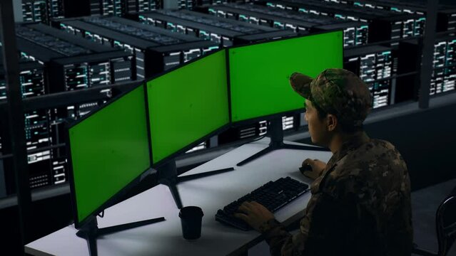 Side View Of Asian Military Thinking About Something While Working With Mock Up Multiple Computer Monitor In Data Center
