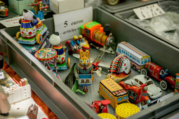 old wind-up children's toys at a flea market in Europe. retro toys in the store's tray. Used old toys