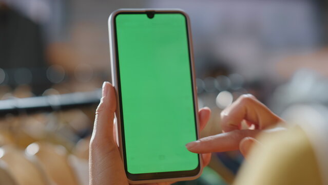 Customer lady scrolling chromakey smartphone mall closeup. Shopaholic browsing