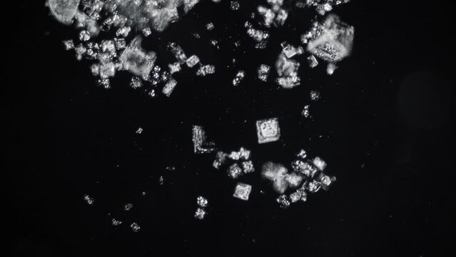 Desalination of sea water. Sea salt crystals under microscope in dark field. 100x magnification. Shortage of drinking fresh water. Evaporation of seas and oceans