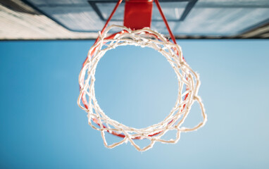 Fototapeta na wymiar Basketball hoop viewed from bottom on the outdoor court