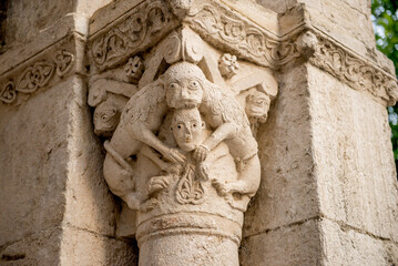 a funny story on a medieval column. ruins, cheerful sculpture. Spain, Besalu