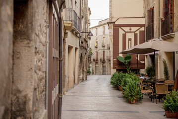 Fototapeta na wymiar an empty cafe on a narrow medieval street