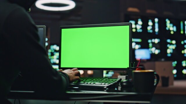 IT technologist coding chromakey computer at datacenter closeup. Man working