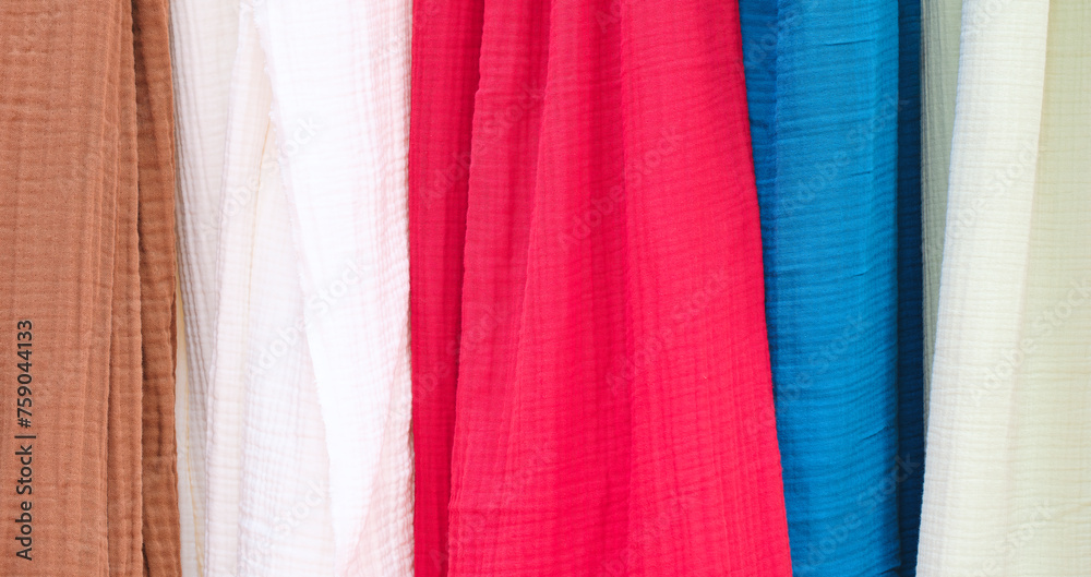 Aufkleber multi-colored textile fabrics hang in a market or store as an abstract background