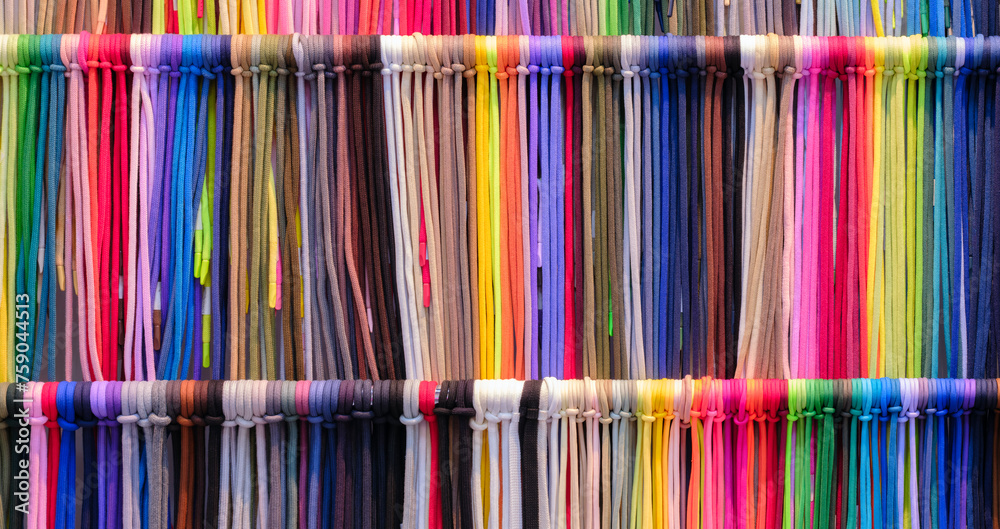 Aufkleber a row of colorful strings laces are displayed in a store. the colors are bright and vibrant, creatin
