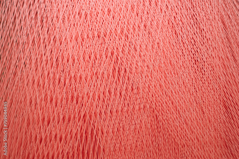 Aufkleber A red threads and fibers with a pattern of lines and dots as a texture background. The fabric is very thick and has a lot of texture
