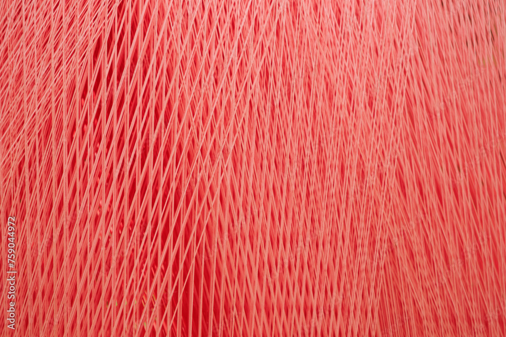 Aufkleber A red threads and fibers with a pattern of lines and dots as a texture background. The fabric is very thick and has a lot of texture