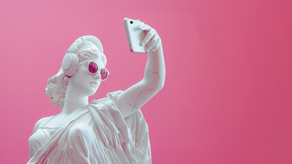Statue of Aphrodite taking a selfie on a pink background