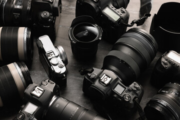 Modern cameras on dark gray table, closeup
