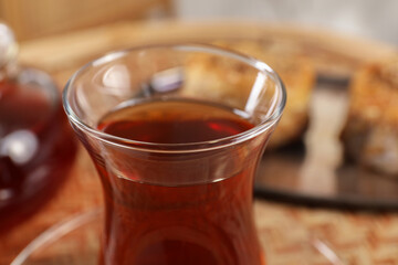 Traditional Turkish tea in glass on table, closeup