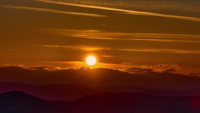 Nature sunset landscape cumulus clouds rolling over hills and mountains time-lapse