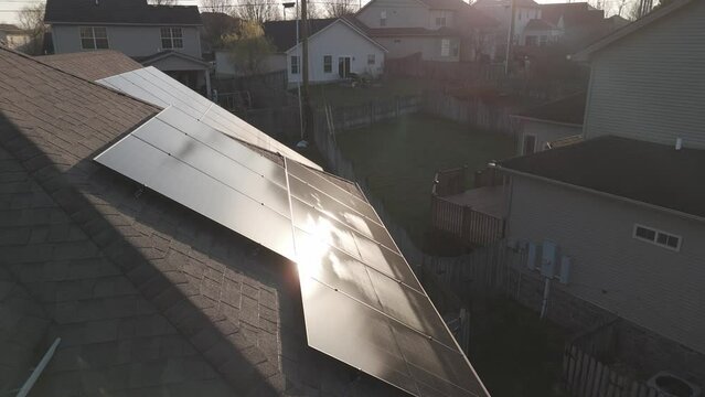 Flying over solar panels installed on the roof of residential home