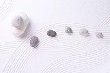  Zen garden stones on white sand with pattern, flat lay © New Africa