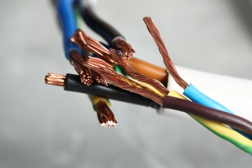 Colorful electrical wires on gray background, closeup