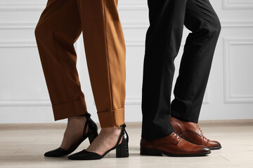 Businessman and businesswoman in elegant shoes indoors, closeup