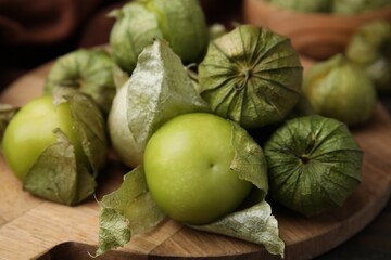 Fresh green tomatillos with husk on table, closeup