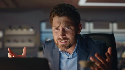 Closeup mad man gesturing hands at evening city view office. Business failure