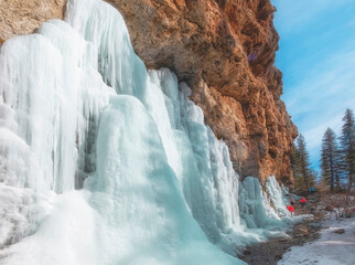 frozen waterfall with huge blue icicles and ice in the mountains. Komershi Gorge in the Tien Shan Mountains Kazakhstan
