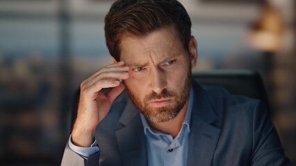 Worried boss thinking face at evening cabinet closeup. Upset man pondering task