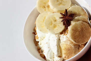 Closeup of Breakfast Bowl of Greek Yoghurt, Cottage Cheese, Granola, and Banana Slices. 