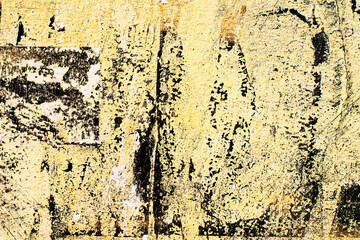 Old abstract wall background. Concrete painted surface with cracks and yellow peeling paint. Grunge background texture	