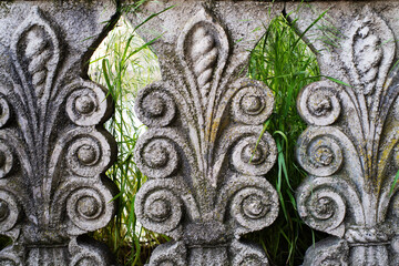 Figured columns of an old concrete fence with floral patterns in Georgia close-up