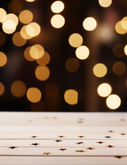 Empty wooden board with star confetti on festive background with golden bokeh. Background for...