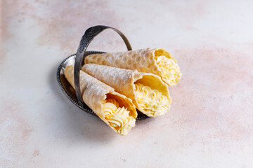 Homemade nut shaped russian soviet cookies and wafer rolls with pastry cream.