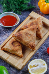 Fried samosas with vegetable filling, popular Indian snacks.